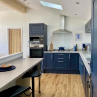 Bespoke lodge kitchen, surfaces fridge freezer, and hob