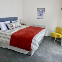 bespoke lodge double bed with folded back red cover